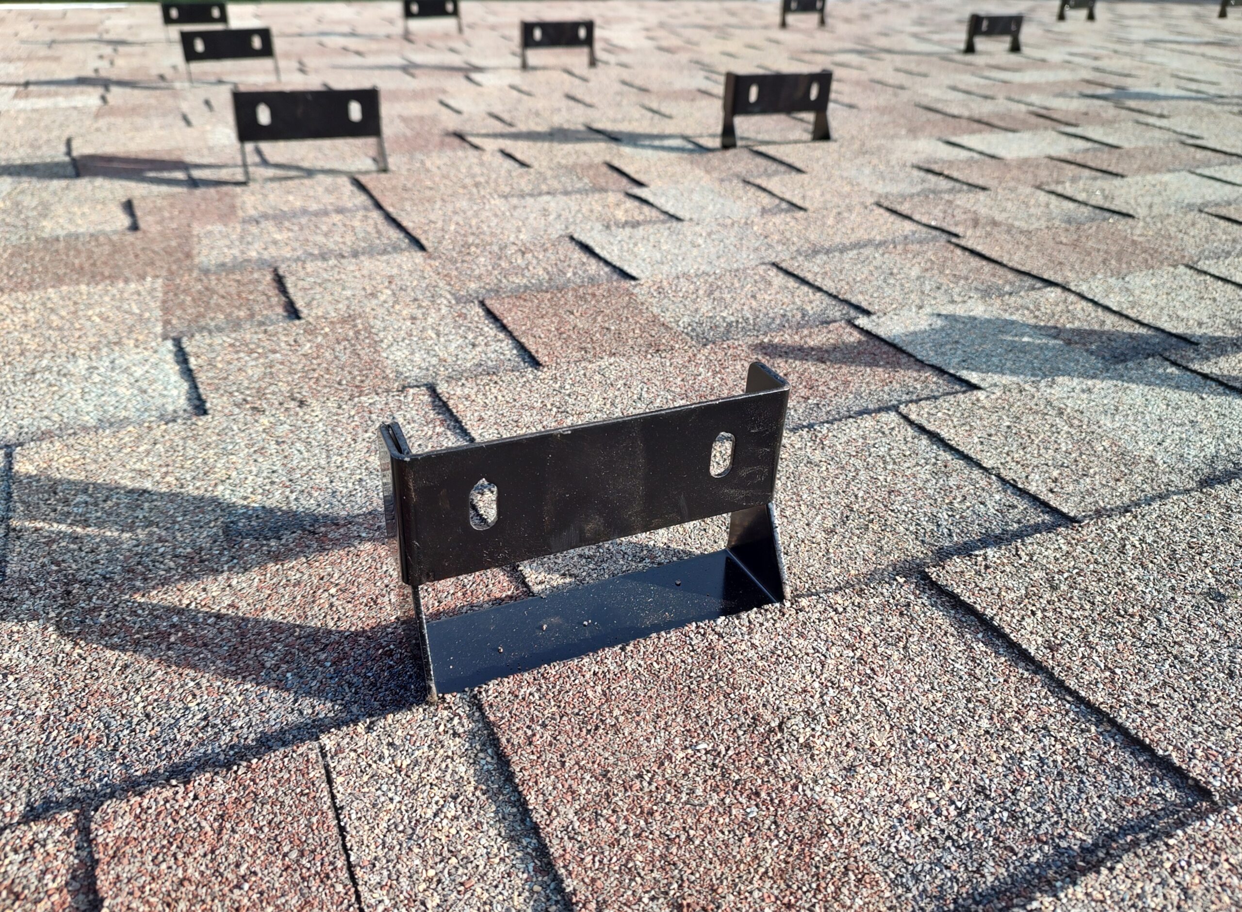 Hidden fastener solar mount requires no holes in exterior roofing layer