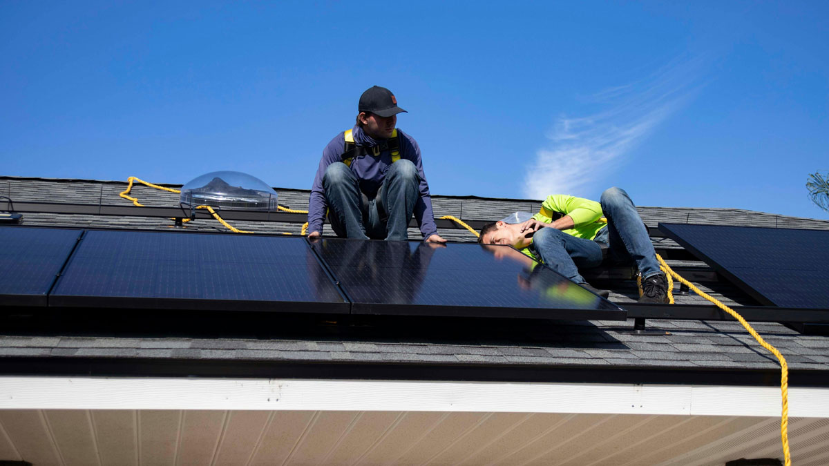 Solar installers on a roof