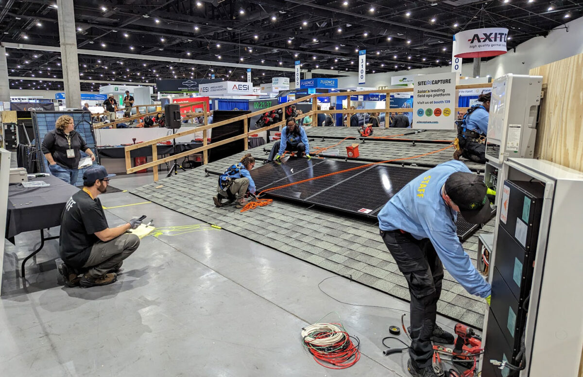 A team of installers working on a dummy roof