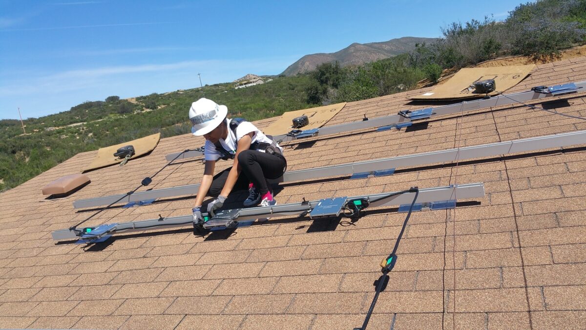 A solar installer attached module-level power electronics to rails in a rooftop installation