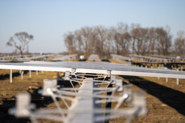 View of solar panels being installed on a long rail