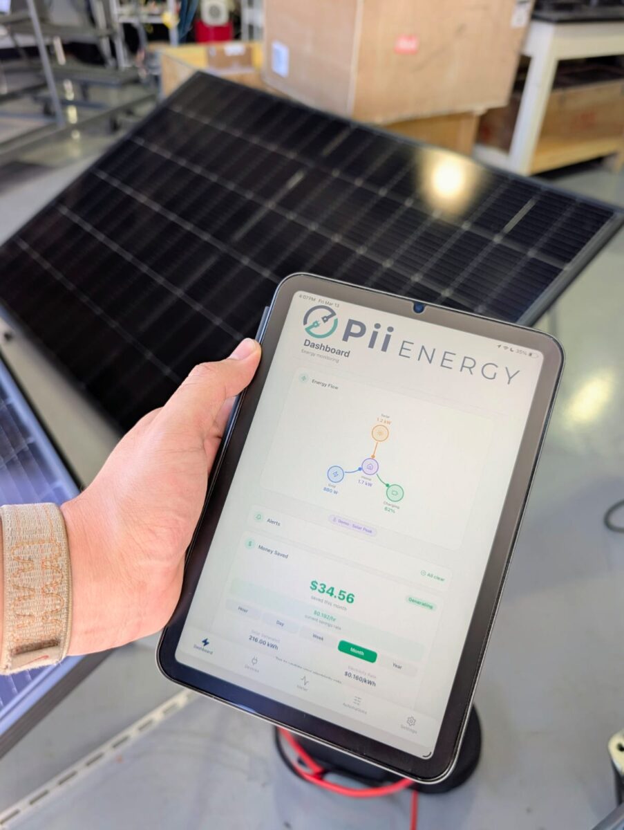 A user holds a tablet with the Pii Energy software running on it