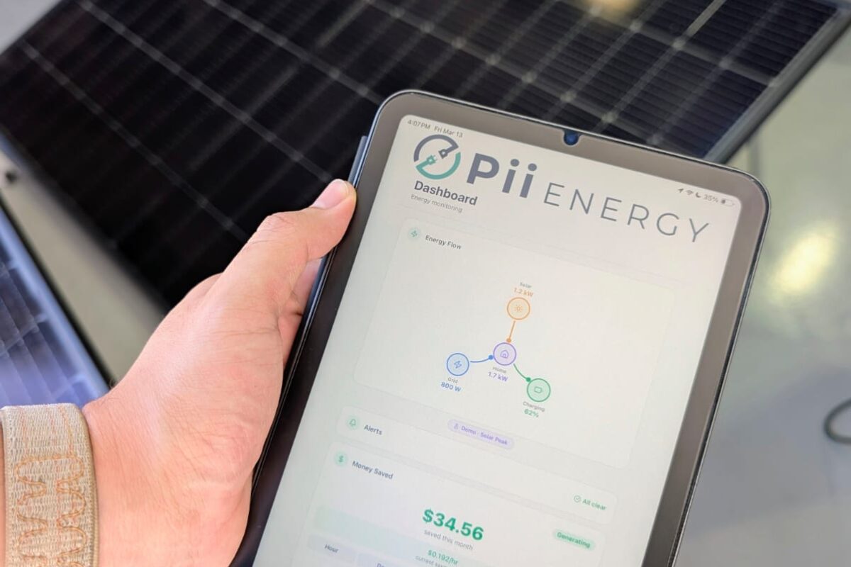 A user holds a tablet with the Pii Energy software running on it